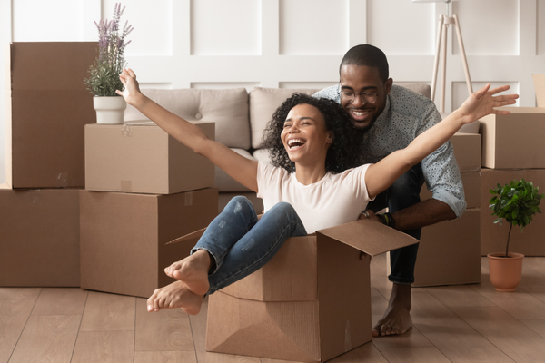 Couple Playing Around In Their New House