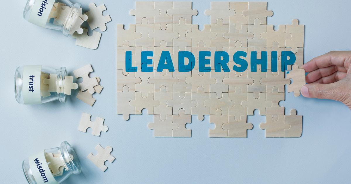 Puzzle pieces coming together to form the word 'leadership'.